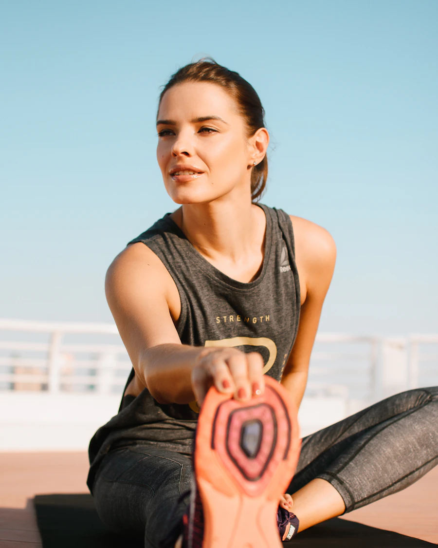 A certified personal trainer stretching, ready for an in-home session